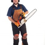 Man dressed in appropriate chainsaw safety clothing