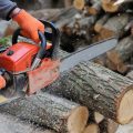 demo of using a chainsaw to cut logs